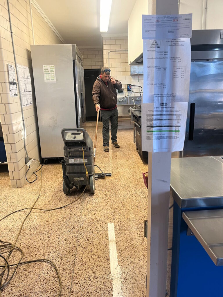 man cleaning and buffing floor